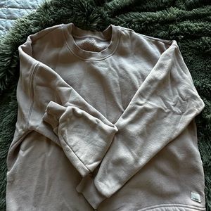 Oversized light pink vuori sweatshirt with ties on the bottom